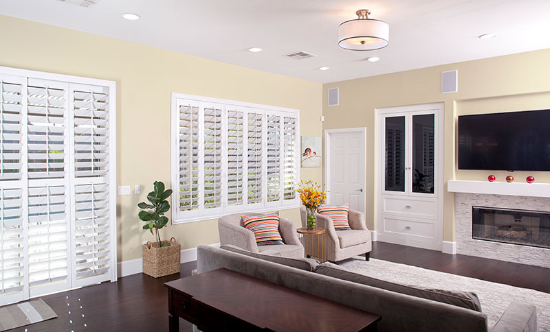 Yellow painted living room with plantation shutters